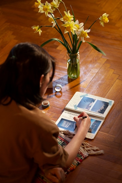 Medium shot woman writing in her journal